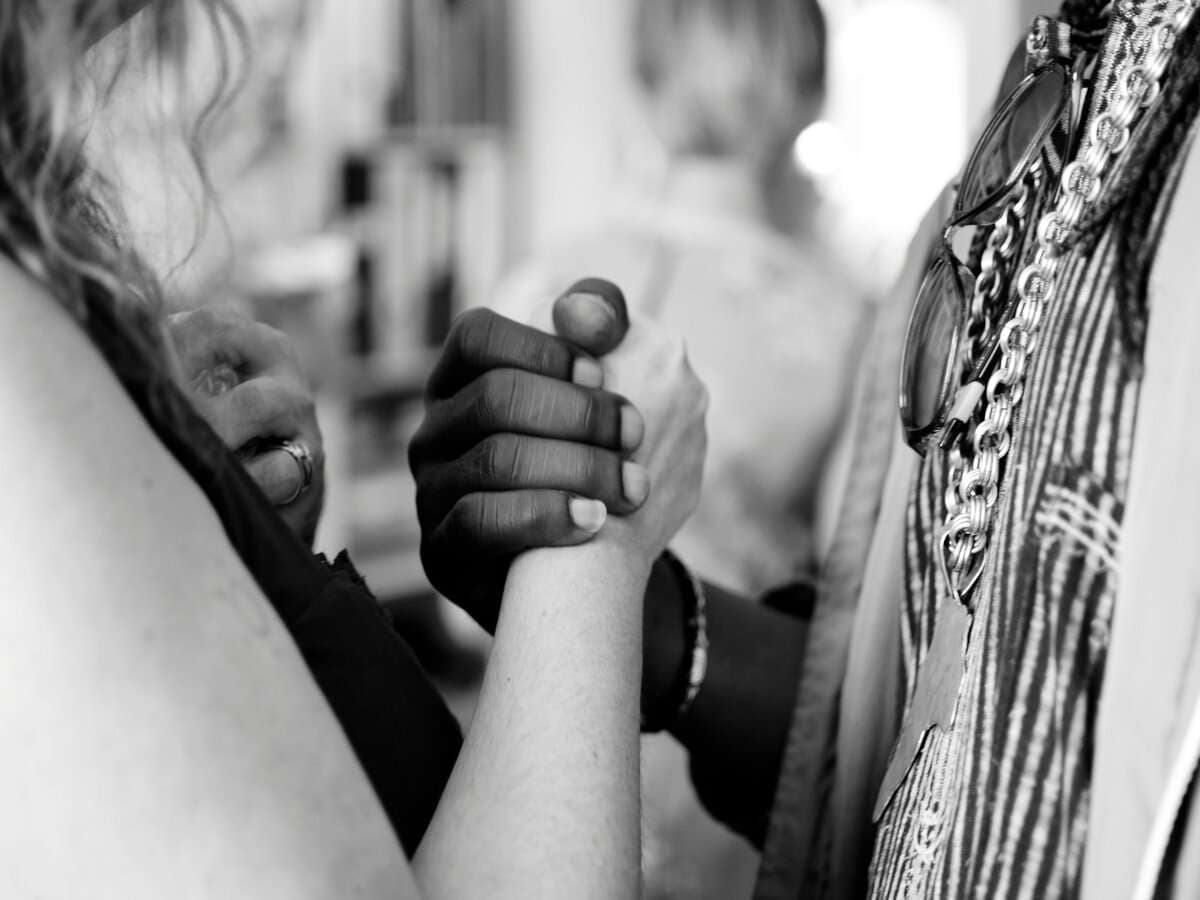 Bridging Divides & Building Unity: The Future of Humanity is Now | Ryan Polly a close-up of hands holding each other