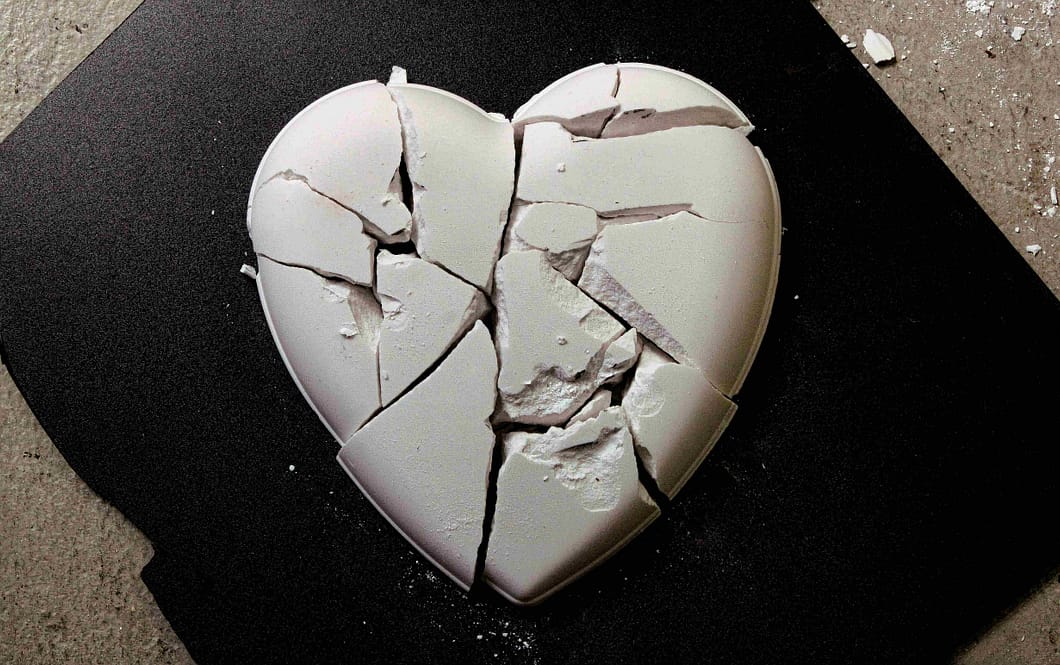 a white heart shaped object with a broken heart