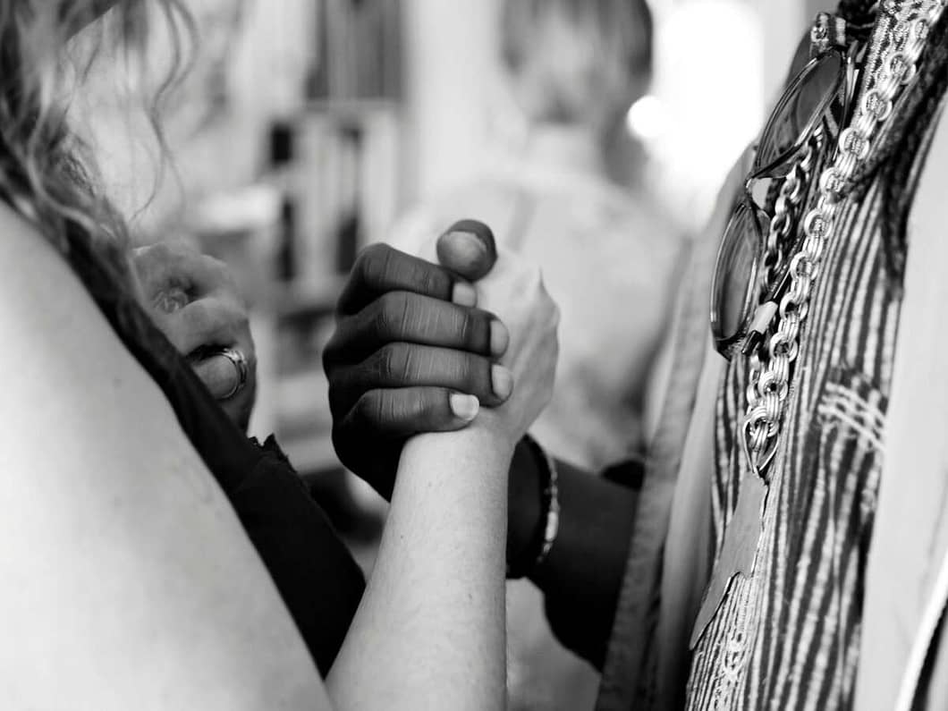 a close-up of hands holding each other