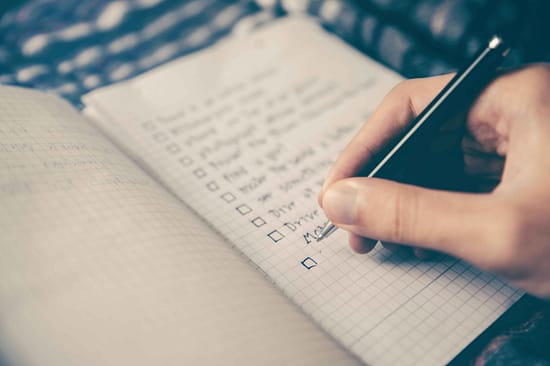 a person writing on a notebook